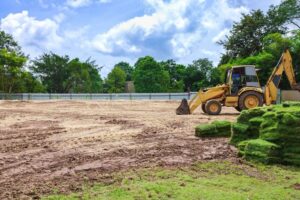 Bulldozer clearing land and leveling soil during a residential land clearing project